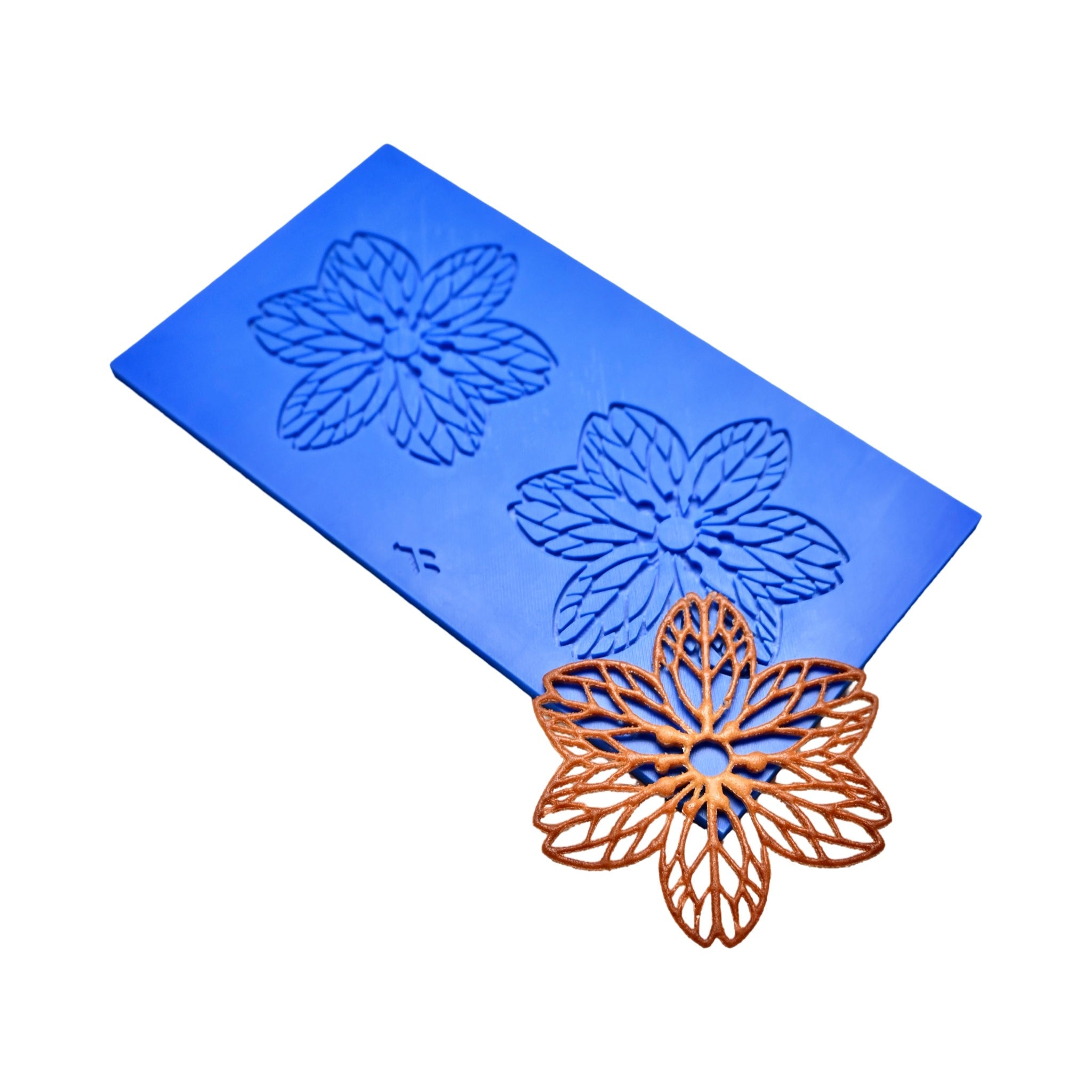Blue Hanami silicone tuile mat with two detailed six-petal flower molds and a golden-brown baked tuile.