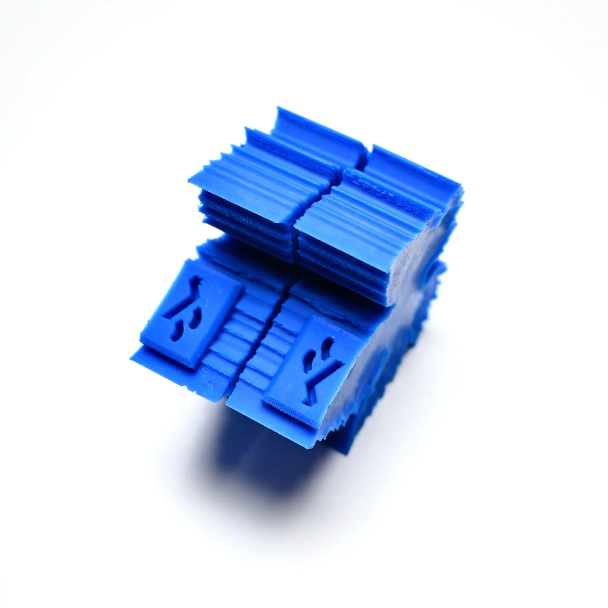 Blue silicone vine leaf press mold with a ribbed, blocky geometric shape.