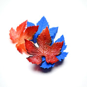 Blue silicone vine leaf molds with realistic red and orange edible sugar paste leaves.