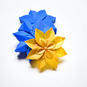 Blue silicone lotus flower mold with a golden yellow pastry replica.