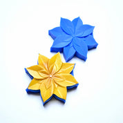 Blue silicone lotus flower mold next to a gold-dusted lotus pastry creation.