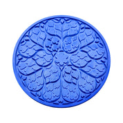Blue circular Regalia silicone tuile mat with intricate floral and leaf-shaped molds.