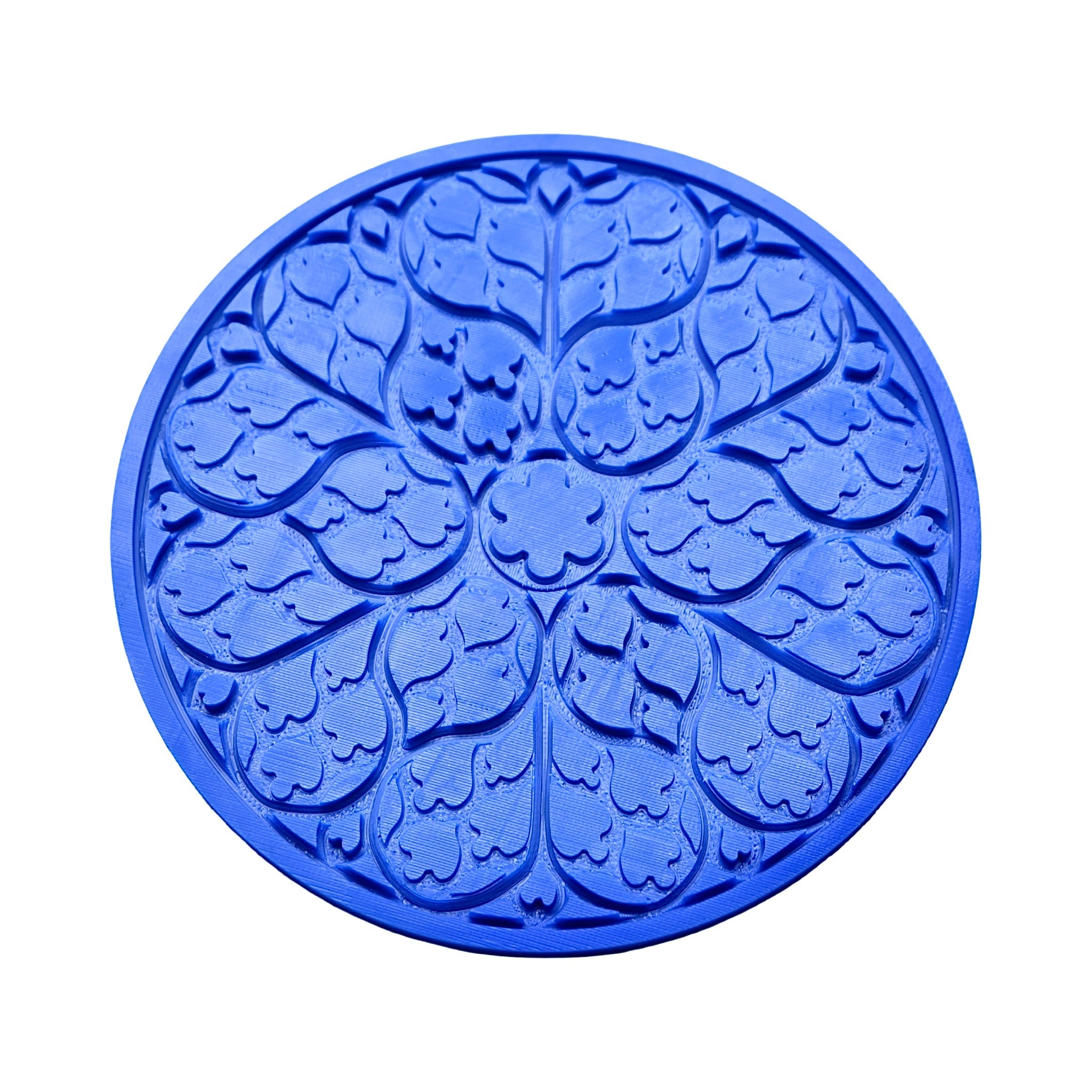Blue circular Regalia silicone tuile mat with intricate floral and leaf-shaped molds.