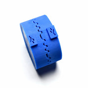 Blue silicone Helix pastry press with a wavy, interlocking spiral mold design.