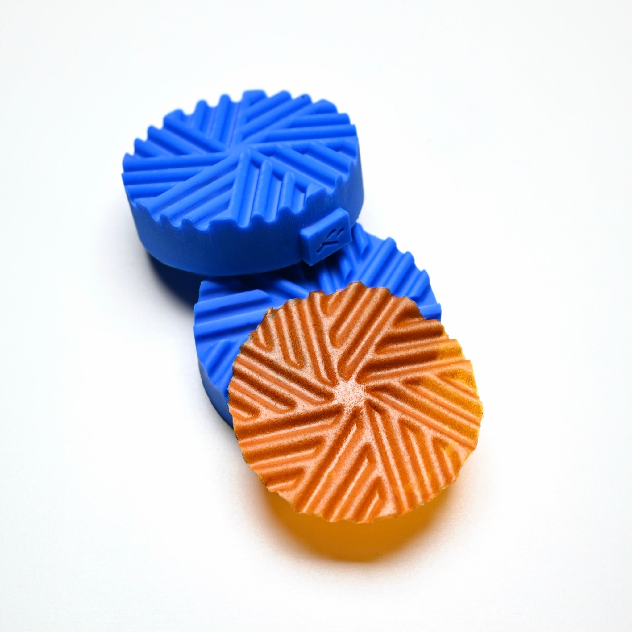 Blue Helix silicone pastry molds with a matching spiral-patterned golden tuile cookie.