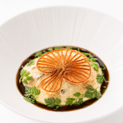 Crispy, golden mushroom-shaped tuile garnish on a gourmet plated dish.