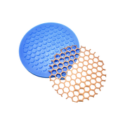 Blue circular silicone honeycomb tuile mold with a matching golden-brown baked tuile.
