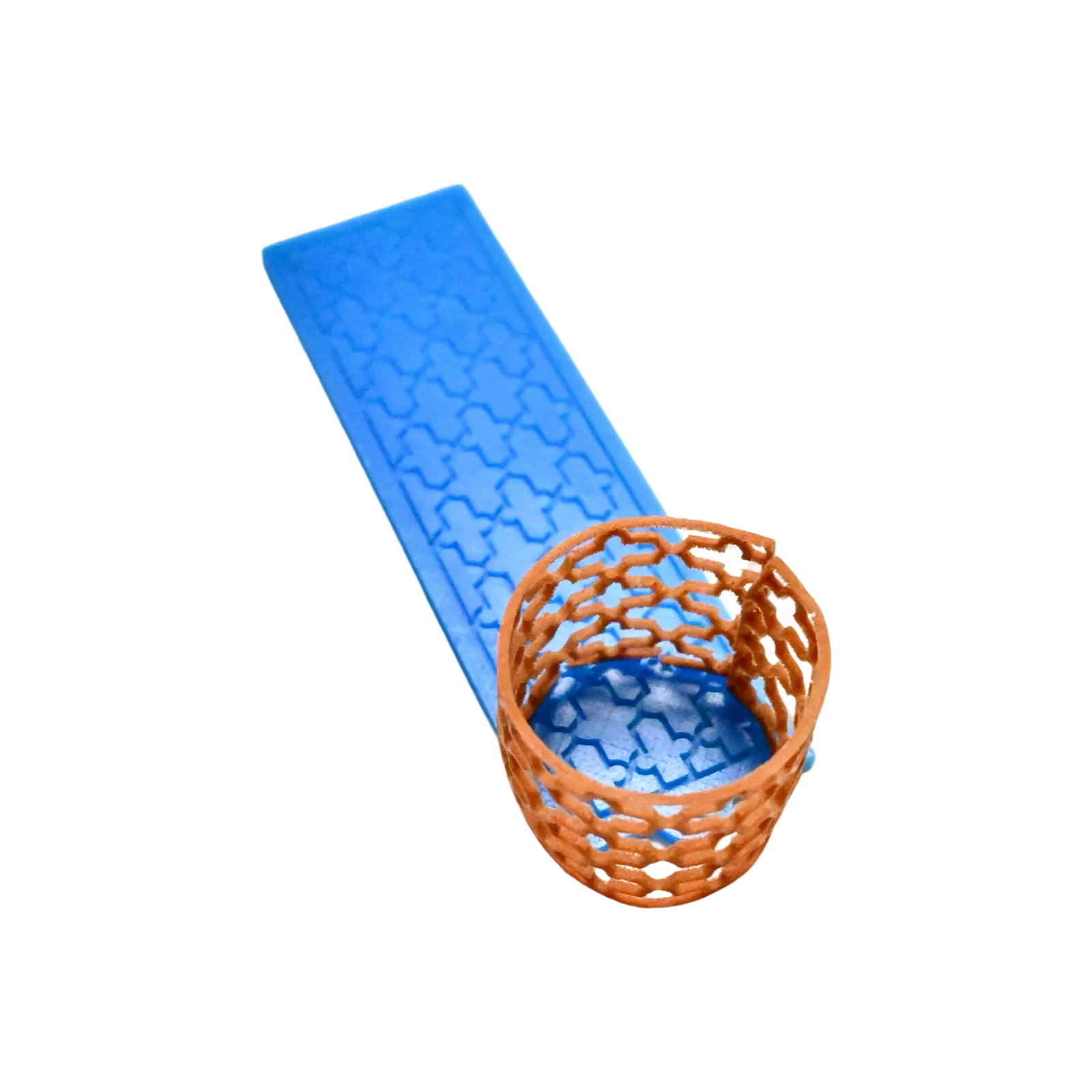 Blue silicone Baroque tuile mold with a brown, cross-patterned lace garnish.