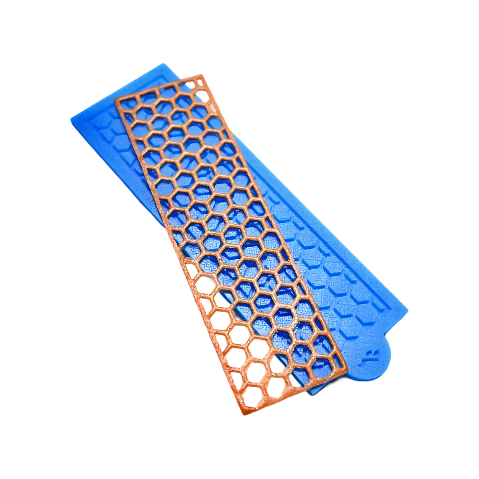 Blue silicone tuile mat with a golden hexagonal honeycomb pattern mold.