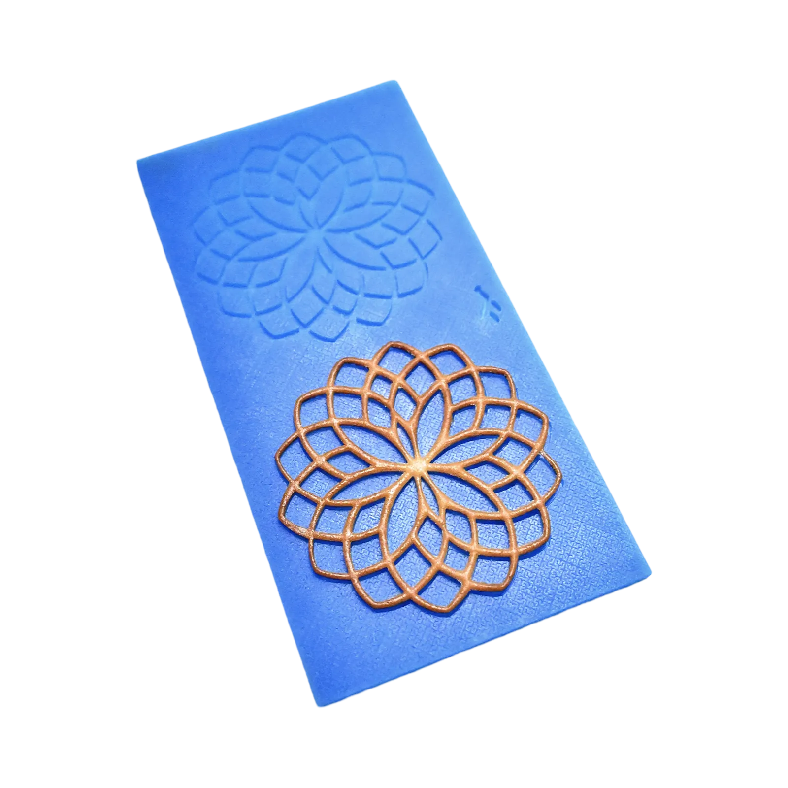 Blue silicone rosette tuile mold with a golden, circular lace-like pastry decoration.