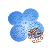 Blue silicone rosette tuile mat with four circular geometric flower molds and a brown baked tuile.