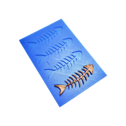 Blue silicone tuile mat with fish skeleton shaped molds and a bronze-colored tuile.