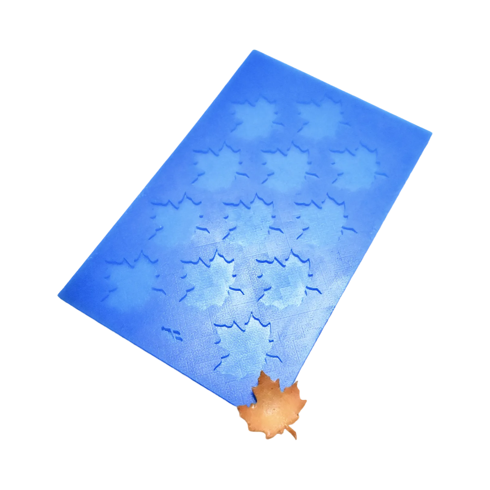 Blue silicone tuile mat with multiple maple leaf shaped mold cavities.