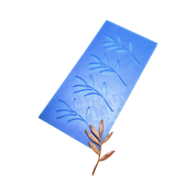 Blue silicone mat with olive branch shaped molds and a bronze tuile garnish.