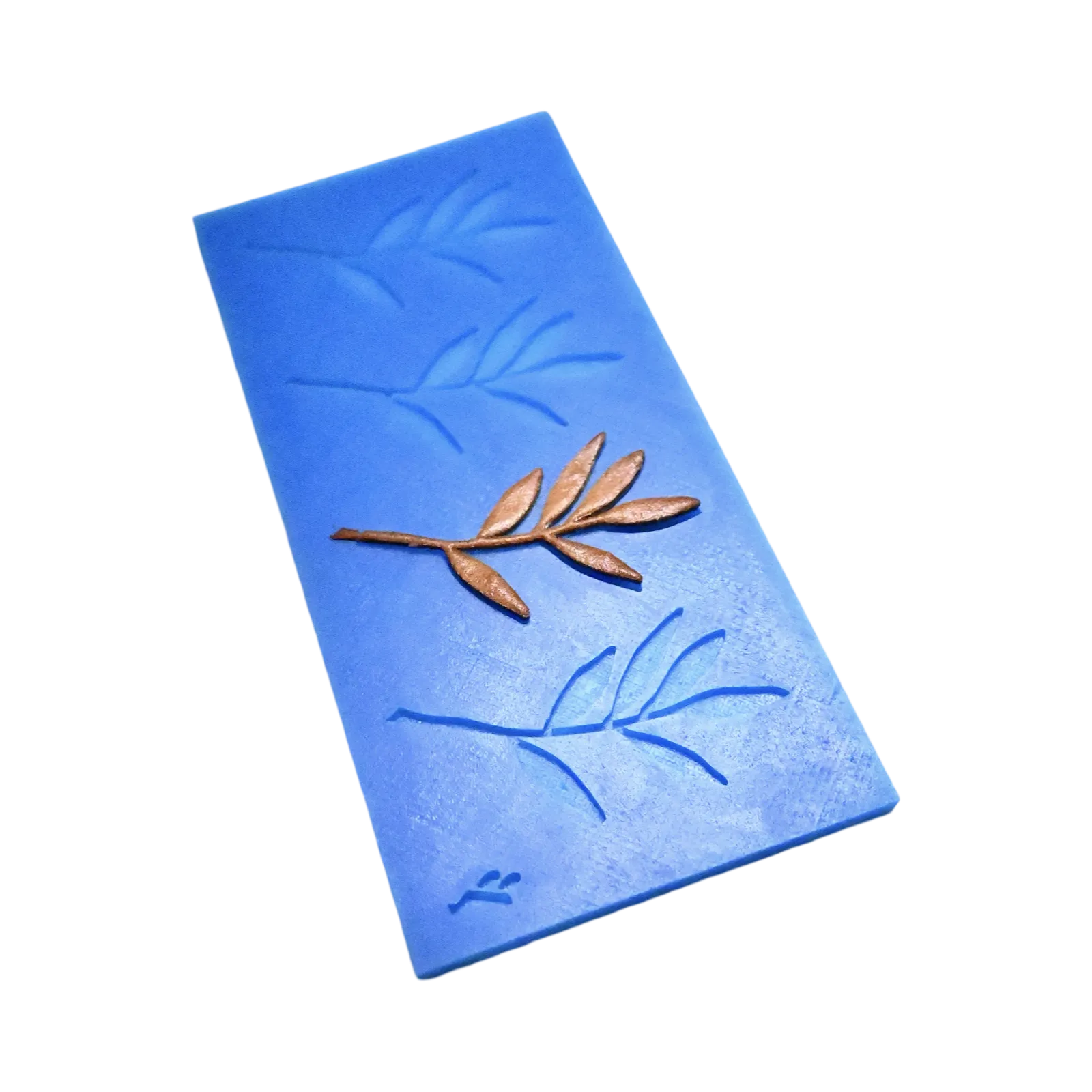 Blue silicone olive leaf tuile mold with a bronze-colored edible branch garnish.