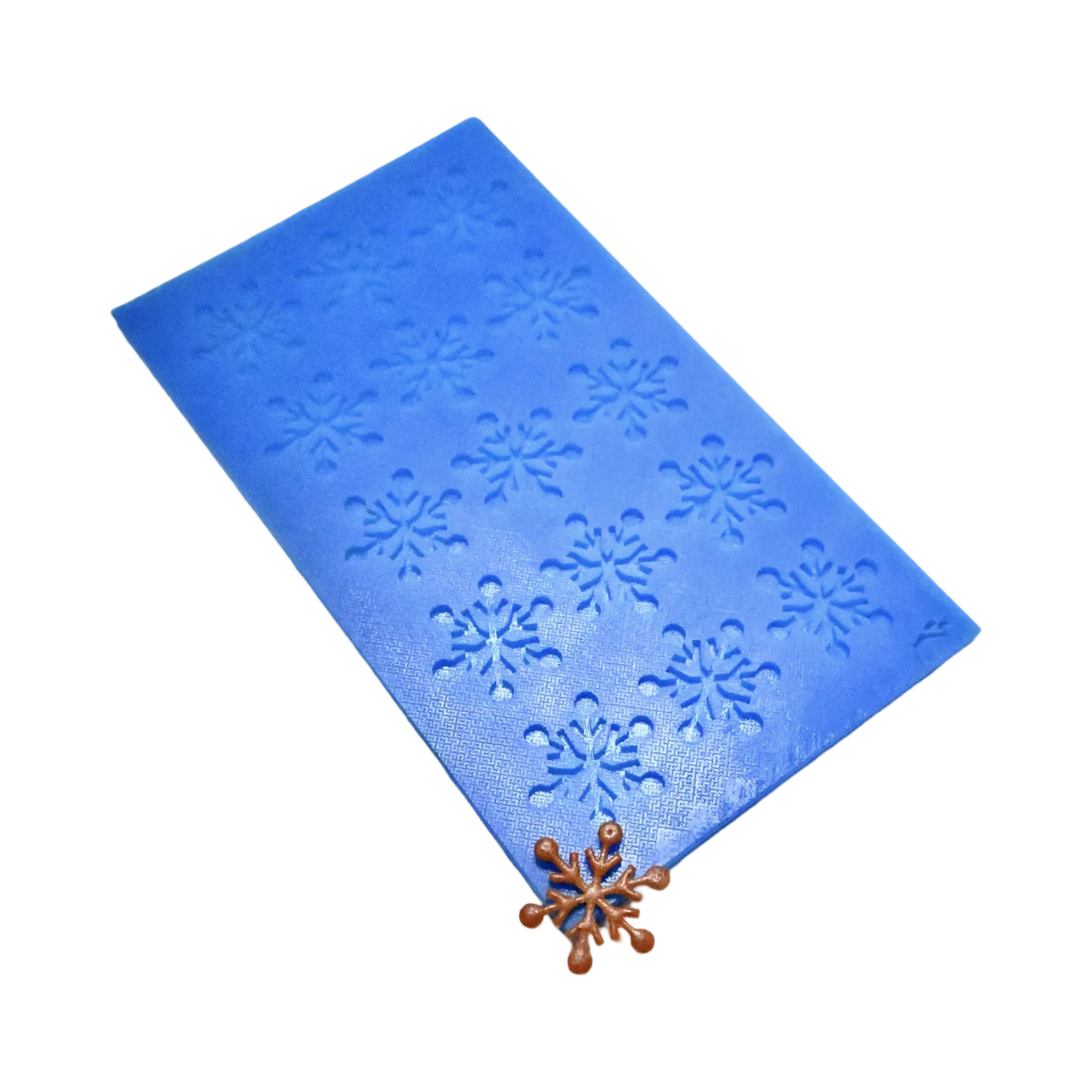 Blue silicone tuile mat with intricate snowflake-shaped molds and a finished bronze tuile.