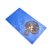 Blue silicone tuile mat with detailed mushroom-shaped molds and a golden-brown baked tuile.
