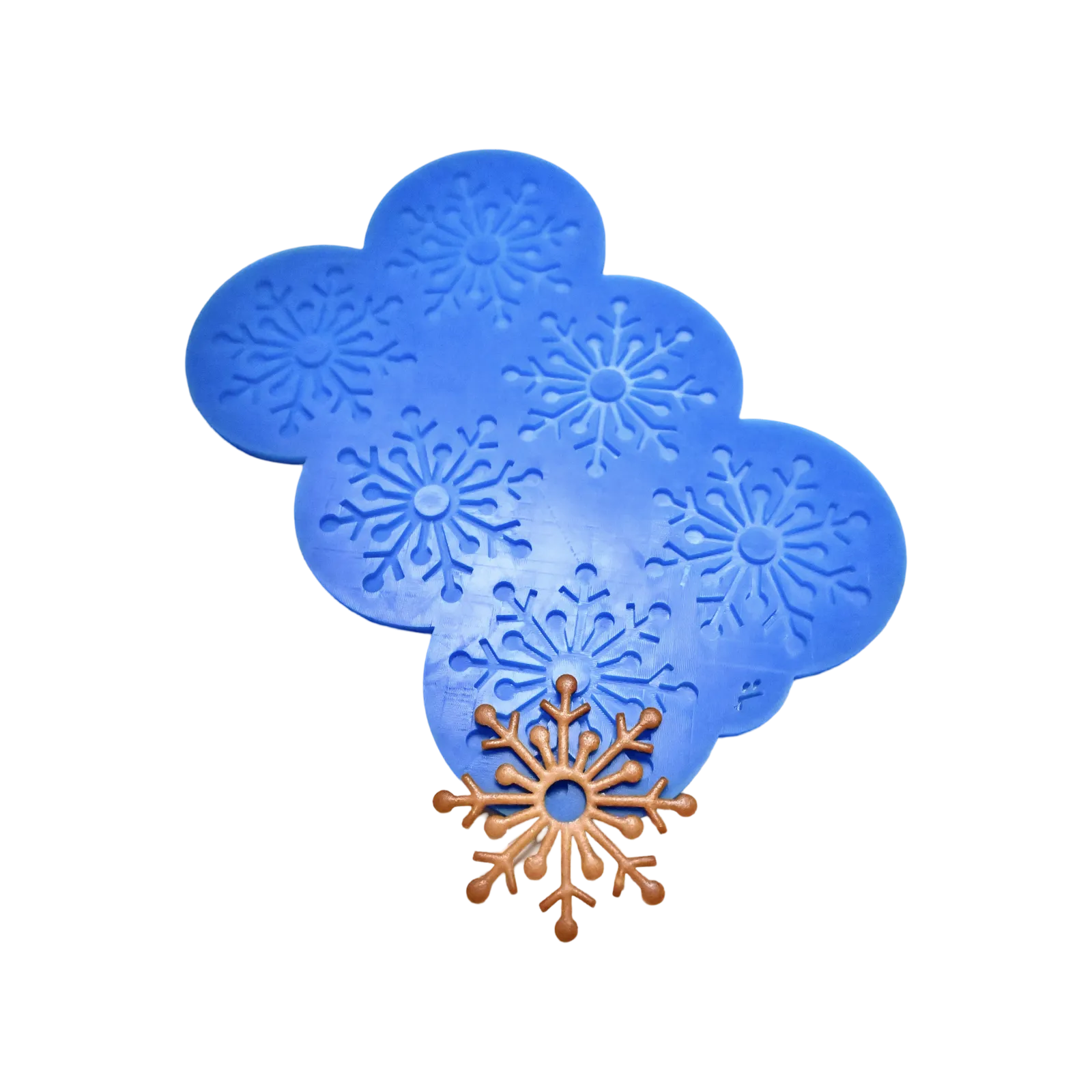 Blue silicone snowflake tuile mold with a brown baked snowflake garnish.