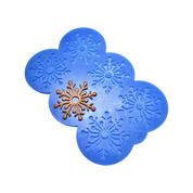 Blue silicone snowflake tuile mold with a finished brown snowflake pastry.