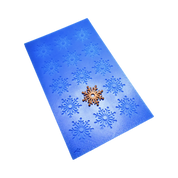 Blue silicone snowflake tuile mold with a golden snowflake pastry on top.