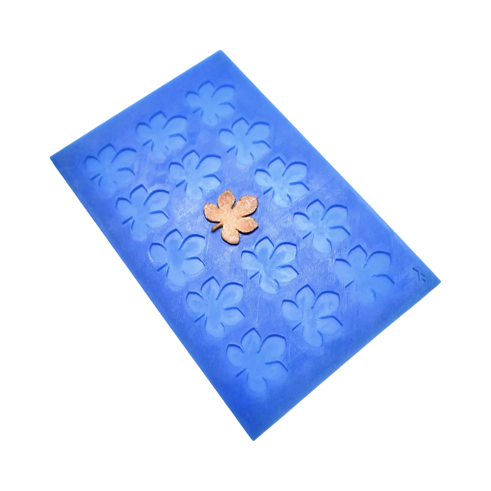 Blue silicone mat with horse chestnut leaf-shaped molds and a golden tuile garnish.