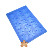 Blue silicone mat with horse chestnut leaf-shaped tuile molds and a golden leaf garnish.