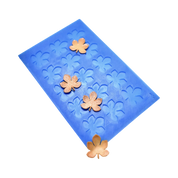 Blue silicone mat with horse chestnut leaf shaped molds and golden tuiles.