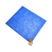 Blue silicone ash leaf tuile mold mat with a finished brown leaf-shaped pastry.