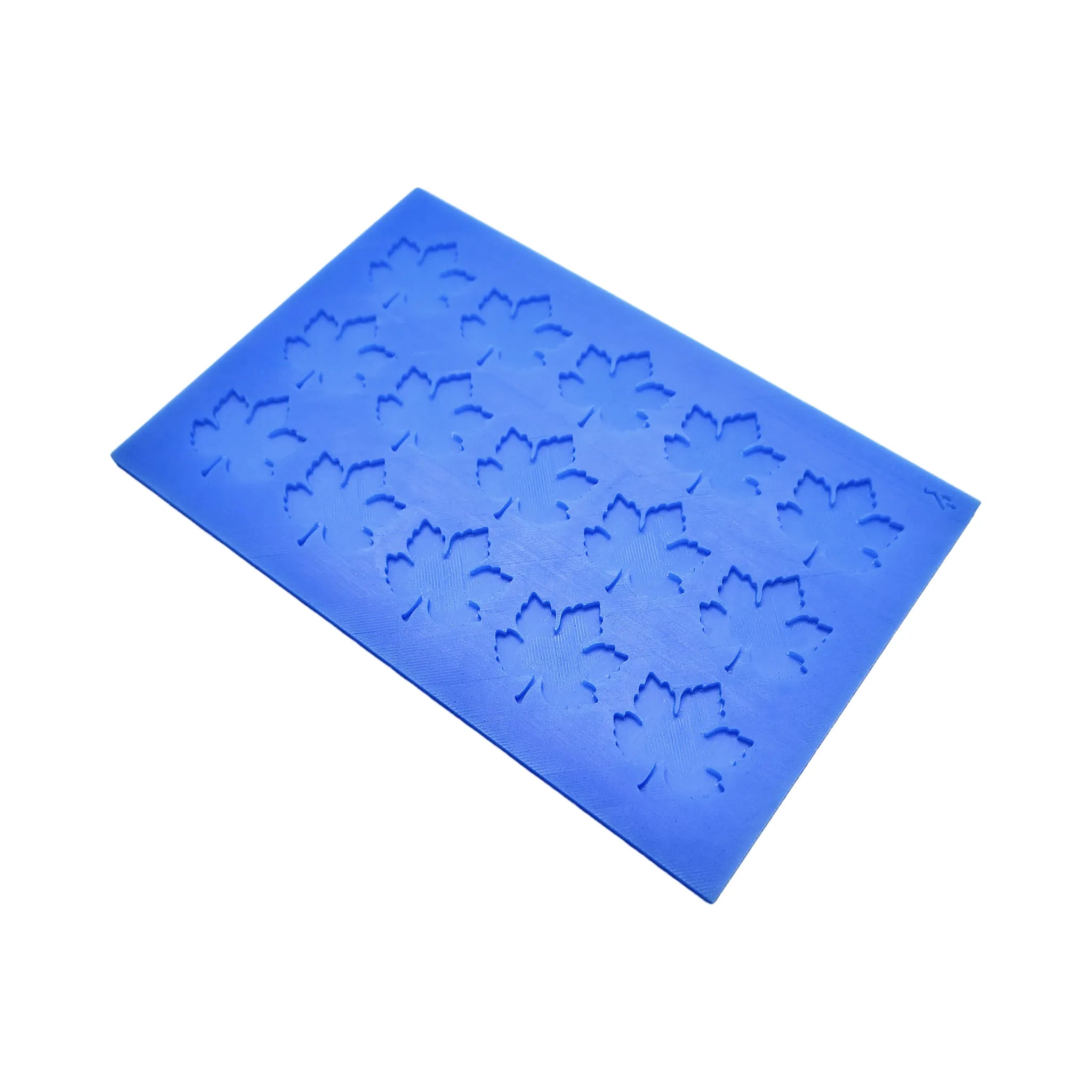 Blue silicone tuile mat with detailed vine leaf shaped molds.