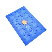 Blue silicone mat with vine leaf shaped molds and a golden leaf tuile.