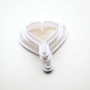 White plastic ginkgo leaf cookie cutters in nested sizes.