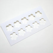 White plastic pastry stencil with ten five-petal strawberry flower cutouts.