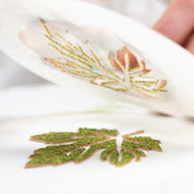 Green textured vine leaf pastry design made using a flexible white stencil.