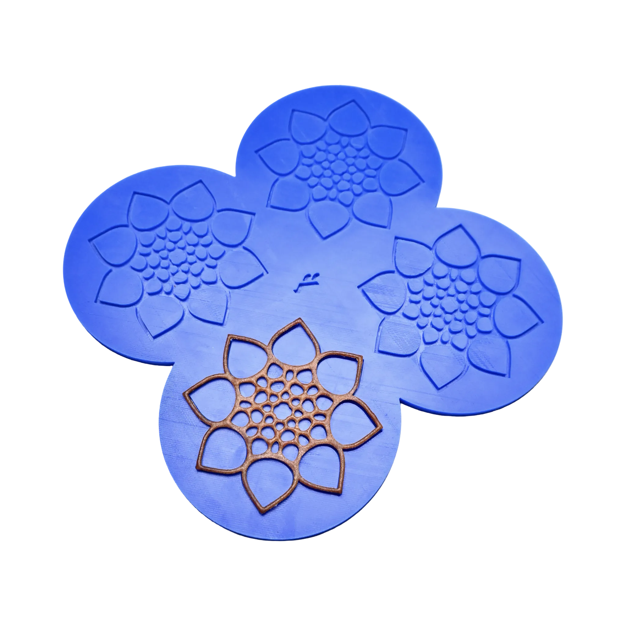 Blue silicone CALYX tuile mat with four detailed botanical flower-shaped molds.