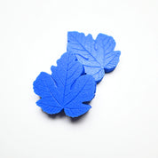 Blue silicone fig leaf veiners with detailed botanical textures on a white background.