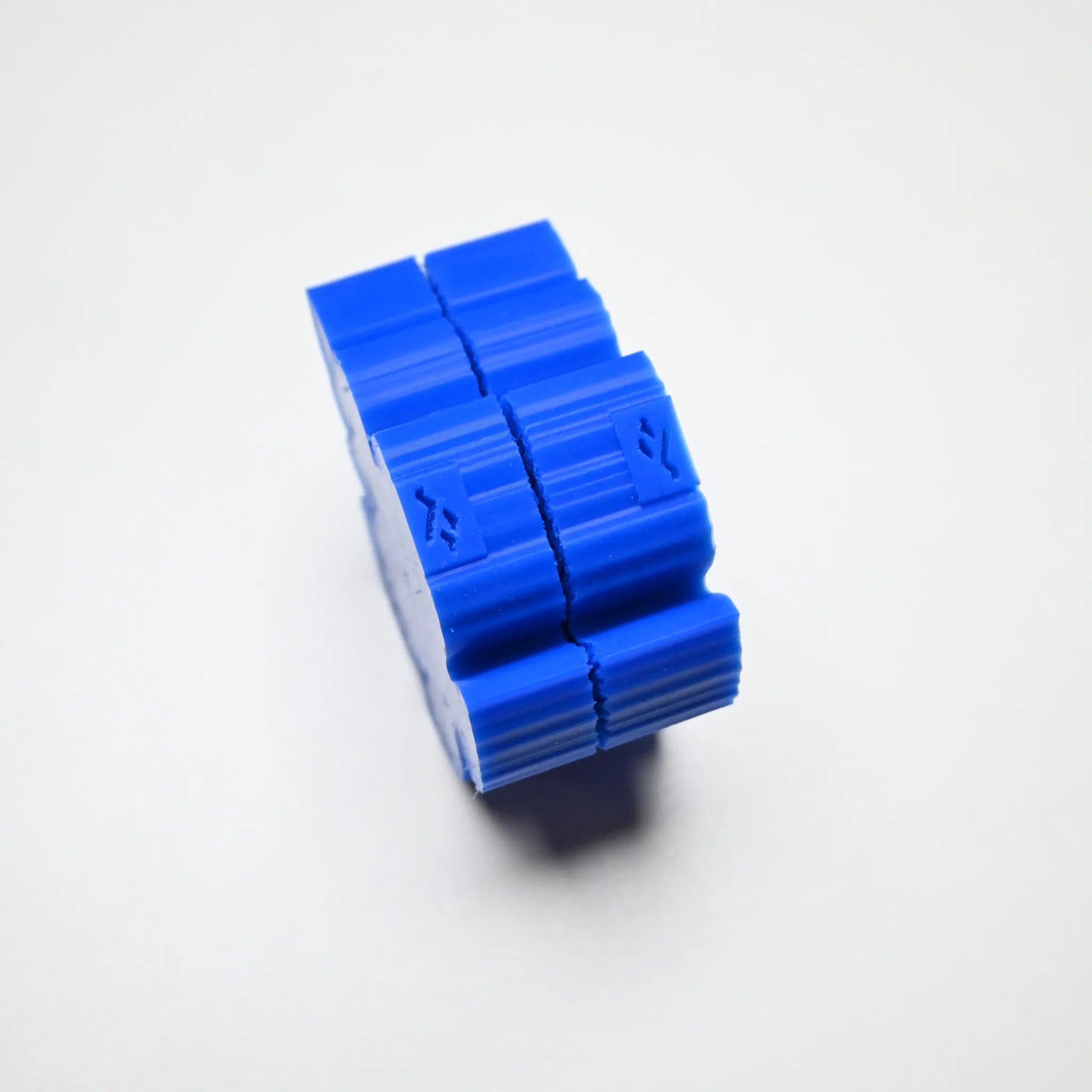 Two-piece blue silicone fig leaf veiner mold with a ridged, interlocking design.