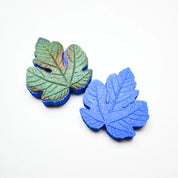 Blue silicone fig leaf veiner mold set showing detailed botanical textures.