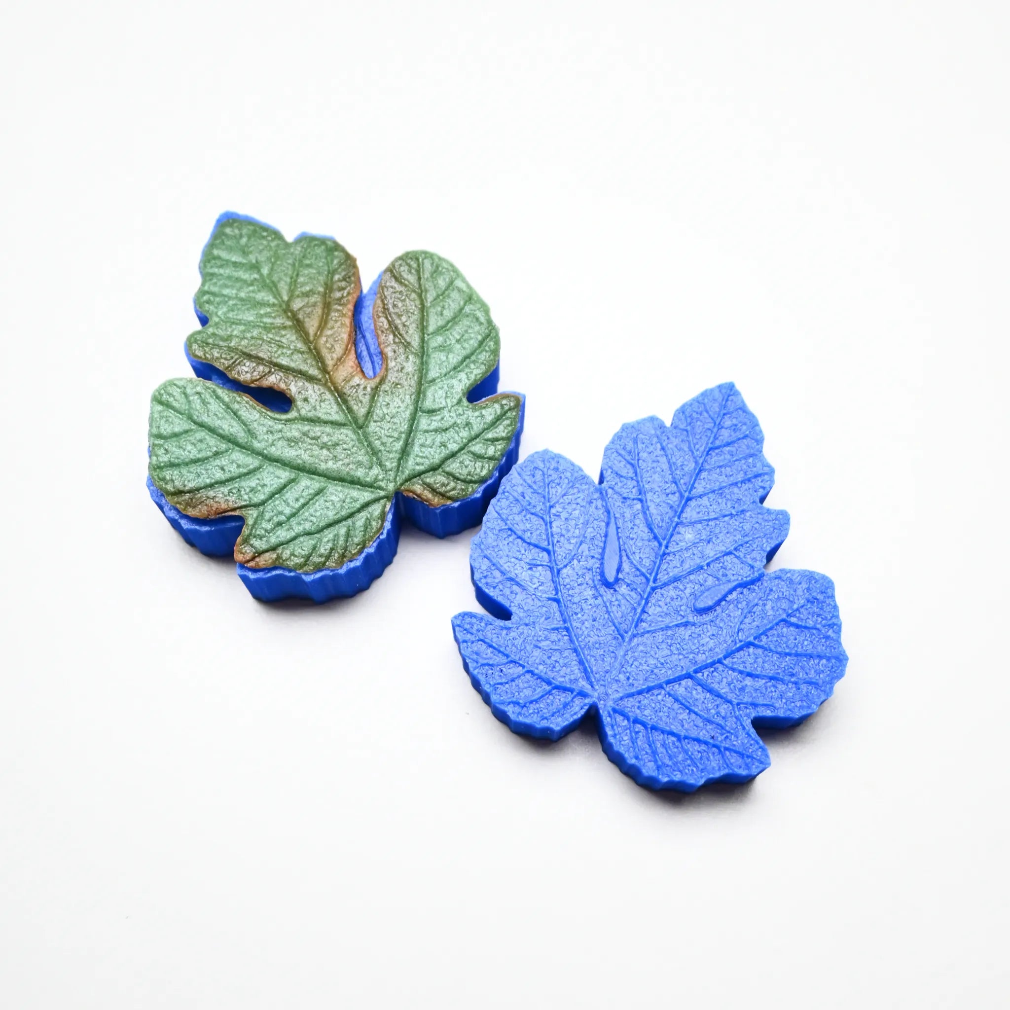 Blue silicone fig leaf veiner mold set showing detailed botanical textures.