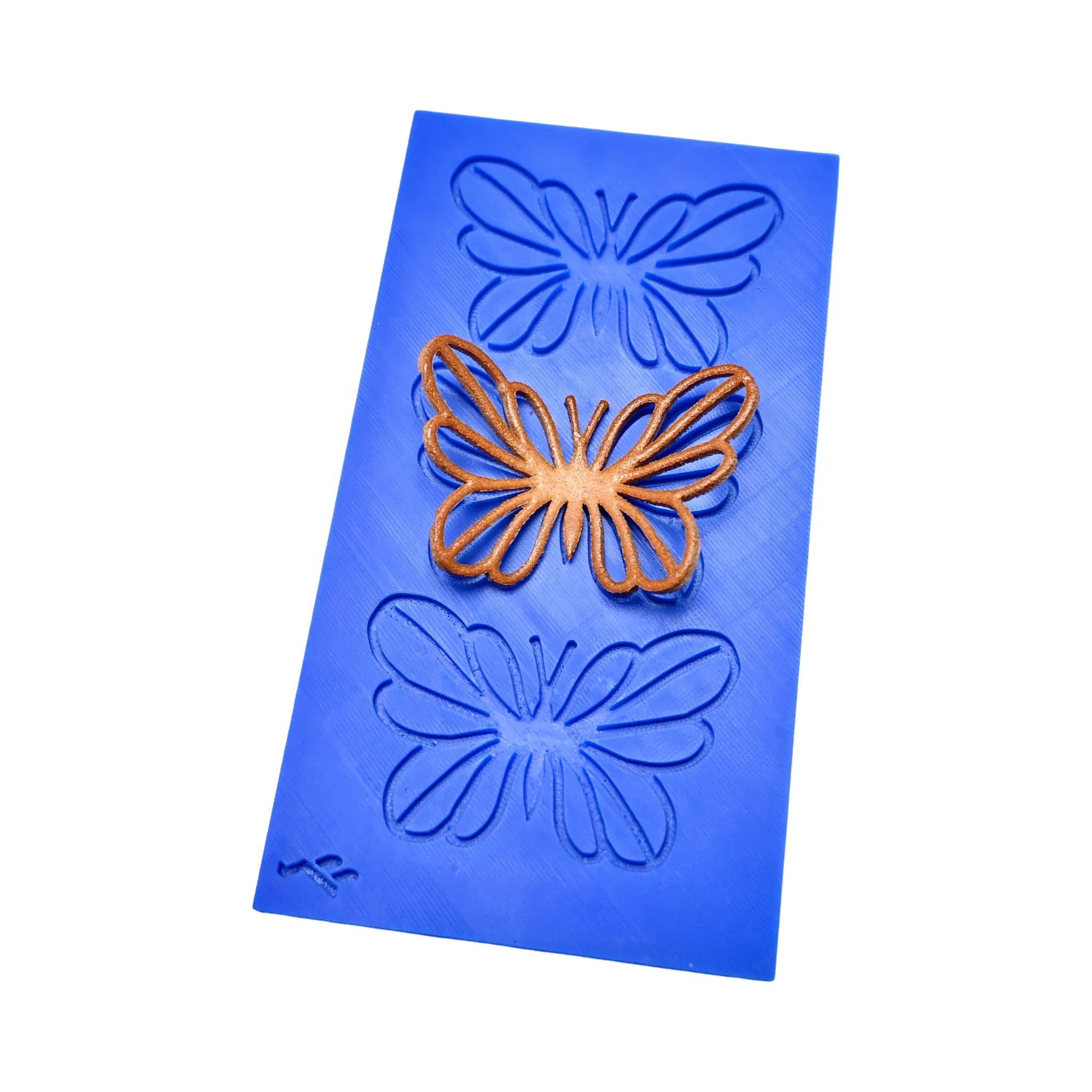 Blue silicone PAPIRYS tuile mat with butterfly-shaped molds and a golden butterfly tuile.