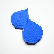 Two blue silicone birch leaf pastry molds showing detailed vein textures on a white background.