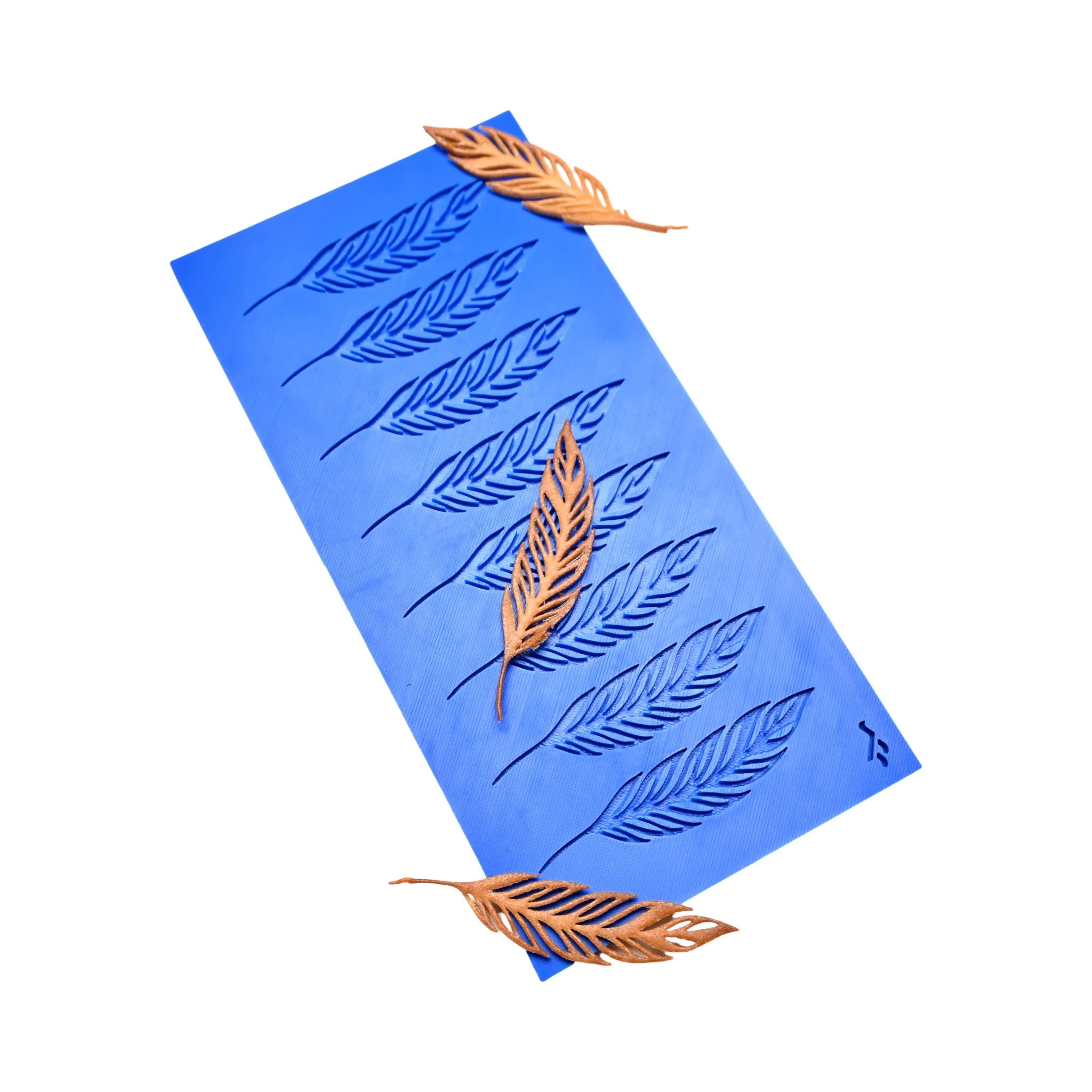 Blue silicone mat with eight feather-shaped molds and golden decorative tuiles.