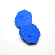 Two round blue silicone nasturtium leaf molds showing detailed vein textures.