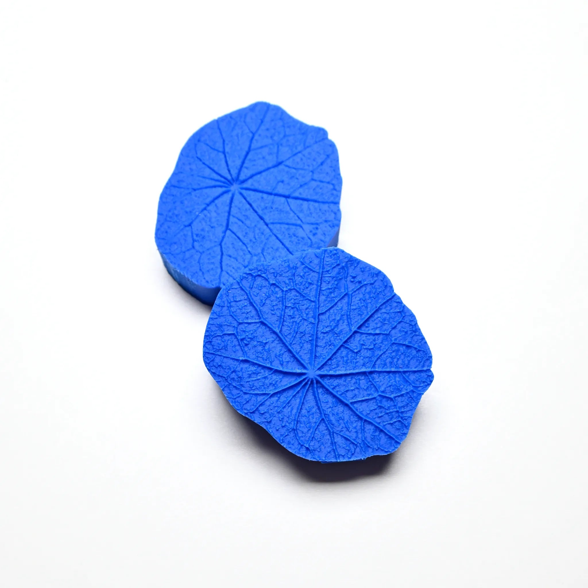 Two round blue silicone nasturtium leaf molds showing detailed vein textures.