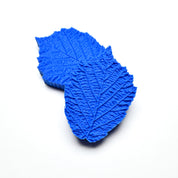 Two blue silicone hazelnut leaf molds showing detailed vein textures on a white background.