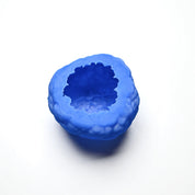 Blue textured silicone truffle mold with a round, irregular shape on a white background.