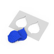 Blue birch leaf silicone press with a matching white stencil template.