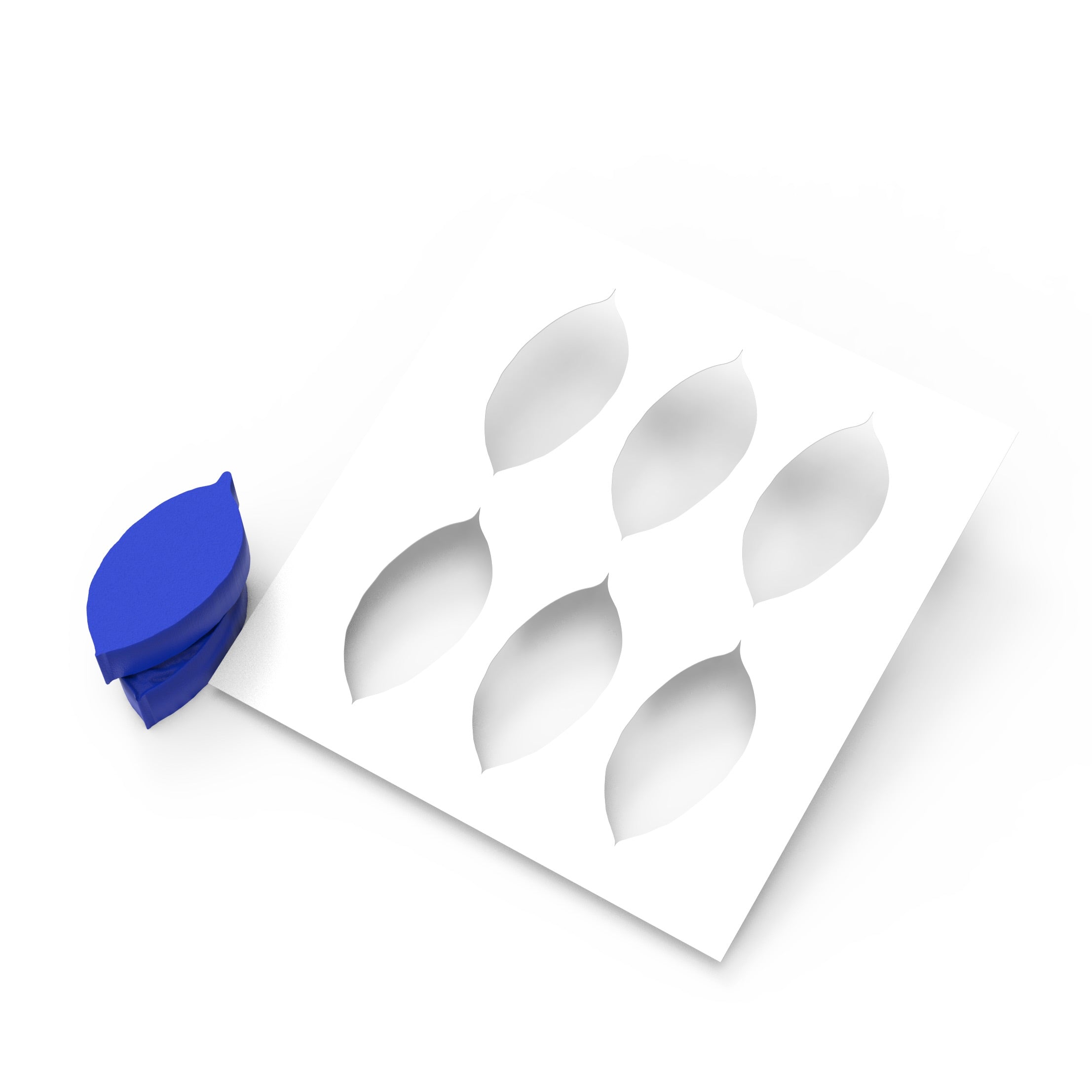 White silicone mold with six leaf-shaped cutouts and a blue coffee leaf press.