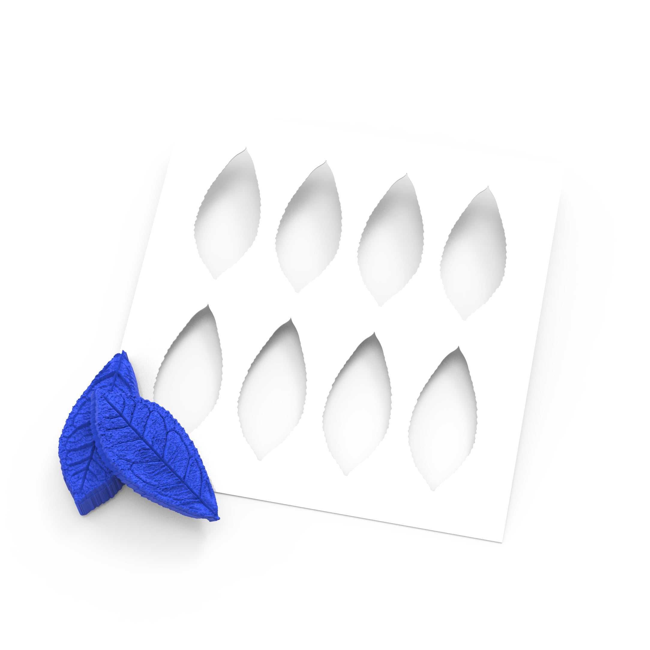 White silicone tea leaf press mold with blue leaf-shaped textured stamps.