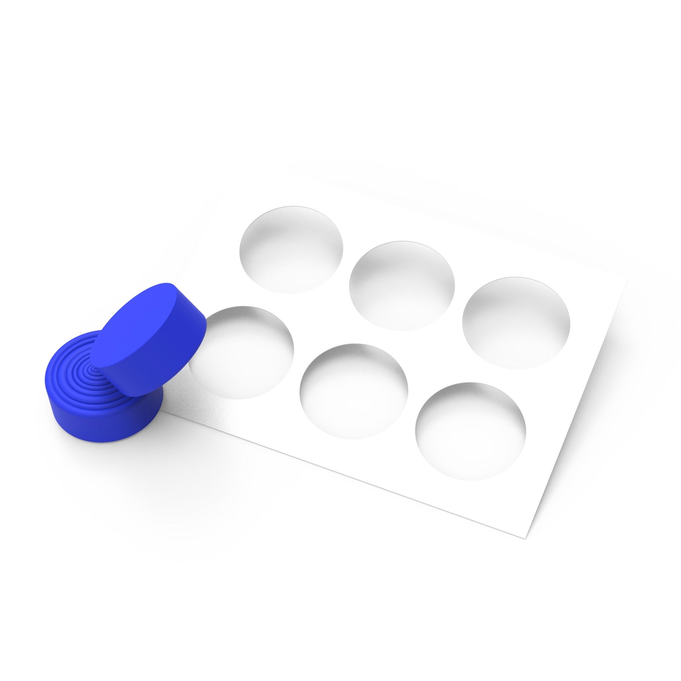 Blue silicone Resonance pastry press with concentric circular ridges and a white stencil.