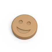 Round tan silicone smiley face mold with a happy expression.